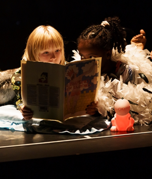 children in costume reading